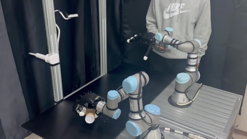 Table-mounted robot handing a tube to a person